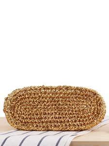 Handwoven gold metallic beach tote bag in a minimalist design on a rustic linen table