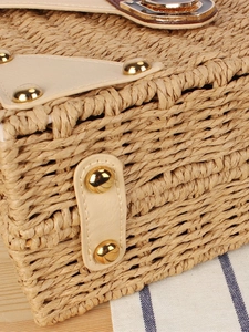 Handcrafted straw woven bag with beige leather trim and gold rivet details for holidays