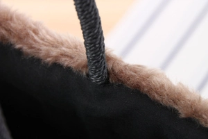 Detail of brown faux fur trim and black woven rope handle on the winter beach bag