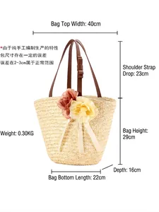 Handmade straw beach tote bag with floral accents and brown straps showing product dimensions