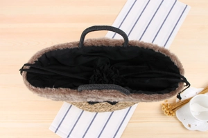Detail of crochet straw bag featuring faux fur trim and secure drawstring inner lining