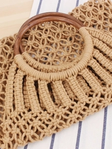 Handmade macrame woven bag with dark brown round wooden handles in bohemian beach style