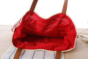 Internal view of crochet tote bag with red lining and convenient open pocket slot