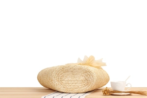 Detailed view of woven straw bag featuring large cream fabric flower and firm oval base