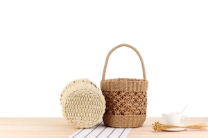 Detailed view of handmade woven bucket bags in cream and tan with drawstring lining