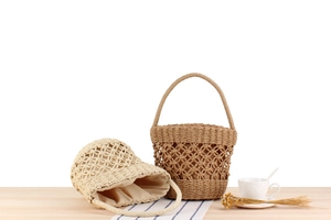 Detail of woven bucket bags in beige and tan featuring hollow mesh and fabric liners