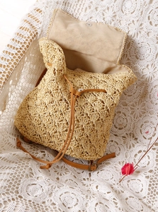 Detailed straw weave pattern and soft fabric lining of the summer beach backpack