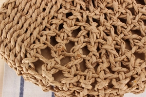 Detailed macro view of beige woven straw texture with hollow knit and fabric lining