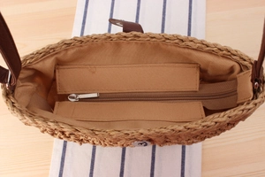 Internal detail of woven beach bag showing brown lining and secure magnetic closure