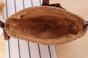 Internal view of handmade straw bag featuring fabric lining and a secure zipper pocket