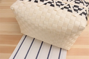 Close-up detail of a handmade woven tote bag with black and white checkered pattern finish
