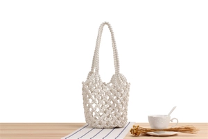 Close-up of white crochet tote bag showing detailed handmade hollow mesh weaving