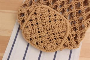 Detail of hand-woven cotton crochet bag showing reinforced round bottom and mesh texture