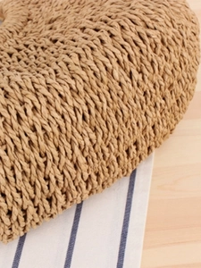 Handmade woven paper rope beach bag with wood handle and textured bohemian style pattern