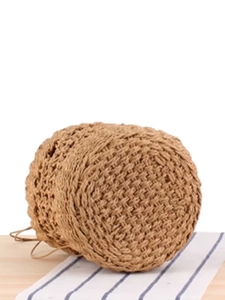 Brown woven bucket bag with intricate cross-grid texture and top handle for beach vacation