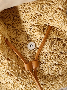 Straw woven summer backpack with hollow pattern, magnetic buckle and leather shoulder strap