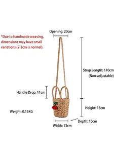 Cute woven straw bucket bag with red cherry accents and adjustable strap for summer