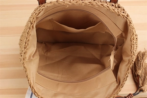 Detail view of woven straw beach bag interior with soft lining and zipper closure