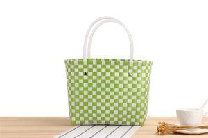 Detailed view of green and white checkered woven tote bag with transparent round handles
