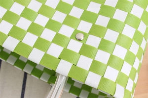 Detailed view of green and white checkered woven bag texture with silver metal buckle