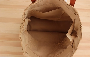 Detail of the woven bag interior featuring fabric lining and zipper closure compartment