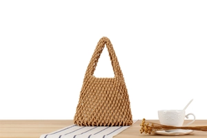 Detailed view of handmade woven cotton rope bag with hollow patterns and inner lining