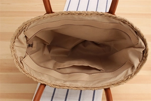 Top view of woven tote bag showing brown fabric lining with interior pocket and zipper