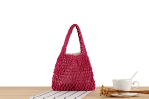Close-up of rose pink woven cotton bag with mesh texture and beige drawstring liner