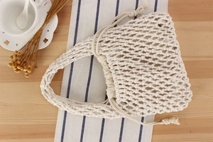 Detail view of handmade hollow woven cotton rope bag with drawstring inner pouch