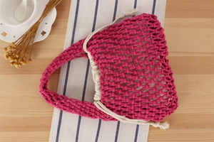Detail of pink hand-woven cotton rope bag with cream drawstring linen liner and tea set