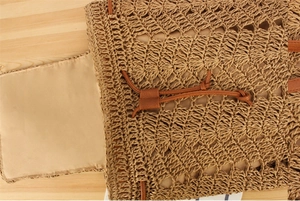 Detailed close-up of woven paper rope texture with interior lining and leather drawstring