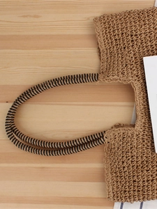 Handmade woven shoulder bag with brown mesh texture and striped handle for summer beach