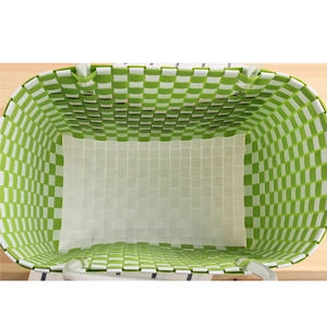 Green and white checkered woven basket bag with durable transparent handles in top view