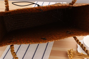 Macro view of woven straw tote bag showing detailed texture and spacious interior