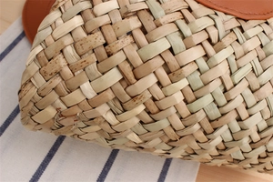 Detailed macro shot of natural woven fiber texture with elegant brown leather trim