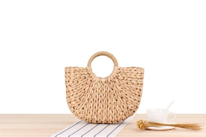 Detailed view of handmade corn husk woven bag with thick spiral texture and round handle