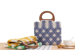 Detailed macro view of checkered macrame weave pattern and round wooden handles