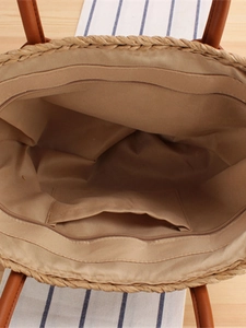 Top view of French plaid straw tote bag interior with zipper closure and brown handles