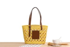 Macro detail of mixed yellow and white paper rope weaving with brown leather straps