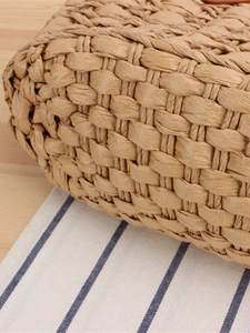 Handcrafted straw tote bag with checkered pattern weave and natural fiber texture