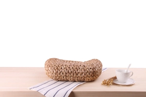 Detail of handcrafted natural corn husk woven texture on a large crescent basket bag