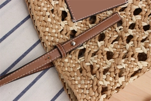 Detailed close-up of textured paper rope weaving and brown leather strap with white stitching