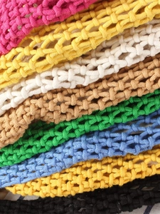 Handmade hollow macrame beach bag in vibrant macaron colors with honeycomb texture