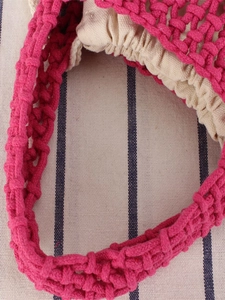 Handmade rose red woven cotton rope beach bag with beige drawstring lining and cutout texture