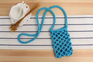 Detail of blue hand-woven cotton mobile phone bag showing intricate mesh knot patterns