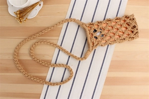 Detail of hand-woven beige cotton rope crossbody phone bag with bohemian net pattern