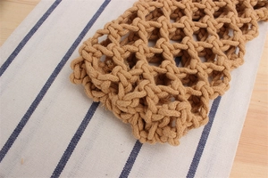 Detailed macro view of the hand-woven cotton rope mesh texture on this bohemian crossbody bag