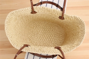 Top view of spacious interior and fine straw weaving details of this beige tote bag