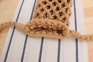 Detailed view of hand-woven cotton rope mesh crossbody bag with bohemian texture