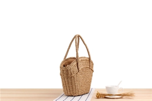 Close-up of a woven straw bag with sturdy handles and soft fabric lining detail